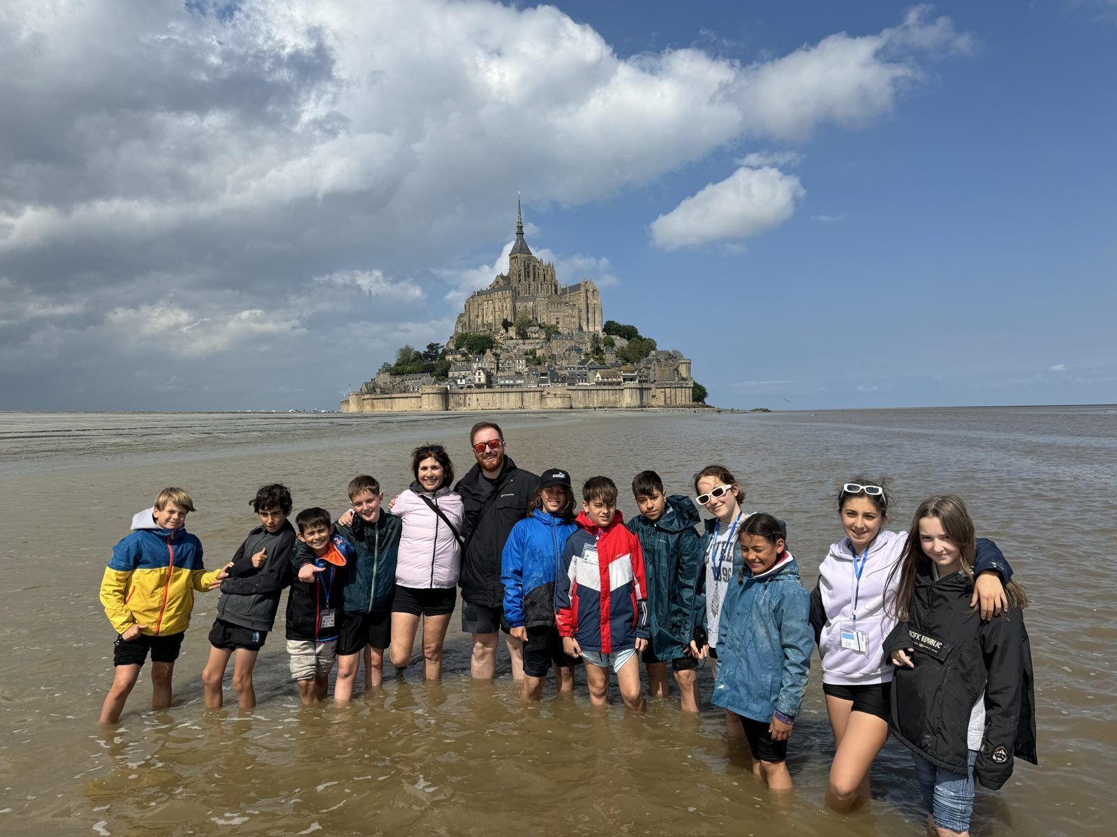 Pupils and teachers walking through the water at Mont Saint-Michel